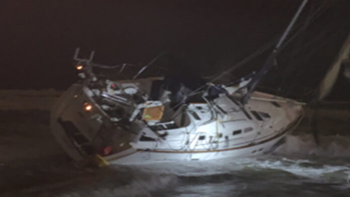 sailboat-battered-by-sally-near-tampa-bay-washes-ashore-on-beach-in-panhandle